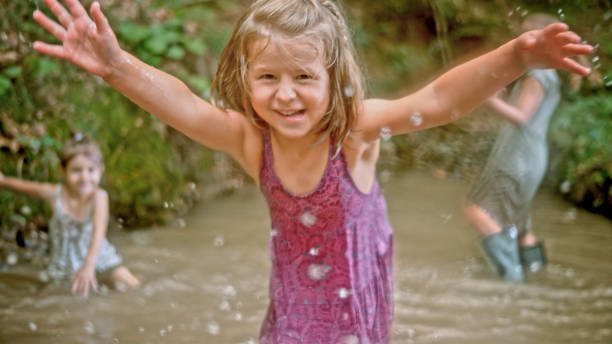 istock Girls playing in water 1132263972
