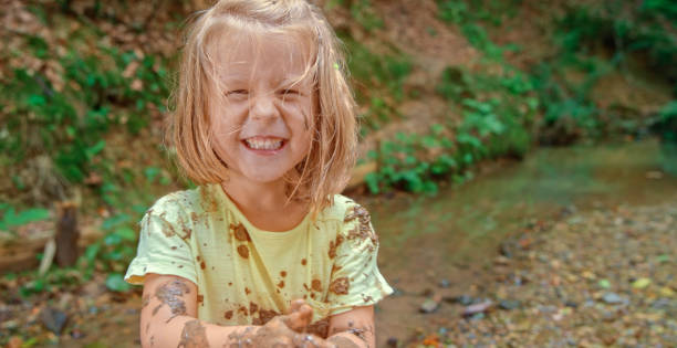 istock Girl playing in mud 1132263980