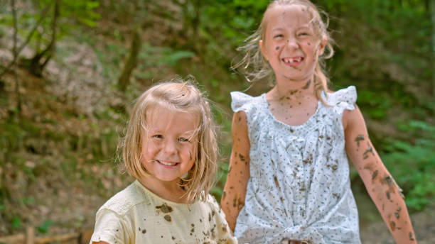 istock Girls playing in mud 1132264001