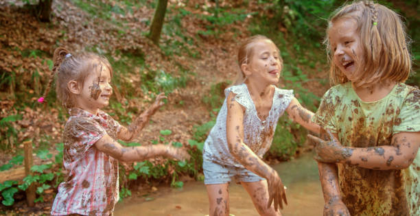 istock Girls playing in mud 1132264013