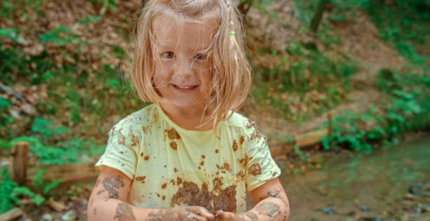 istock Girl playing in mud 1132264023