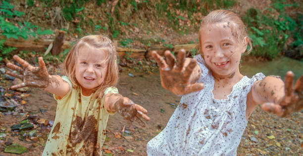 istock Happy girls playing in mud 1132264026