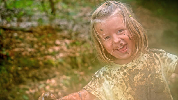 istock Girl playing in mud 1132264045