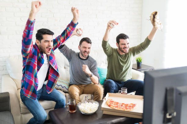 istock Friends Screaming Cheerfully While Watching Sport On TV 1132264083