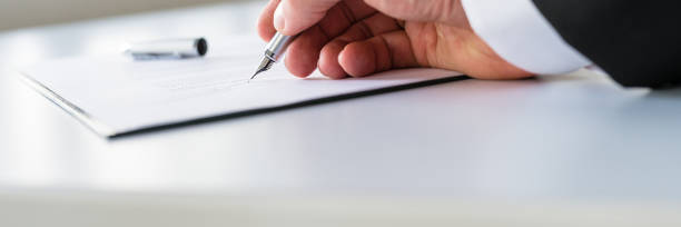 Businessman signing contract Closeup of businessman signing contract with ink pen. petition stock pictures, royalty-free photos & images