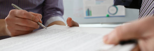 istock Female arm offer contract form on clipboard pad 1132264221