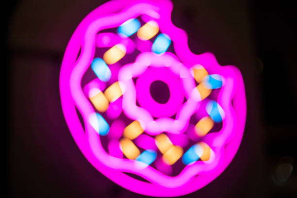 istock Donuts bright neon sign on cafe entrance on black background. 1132266170