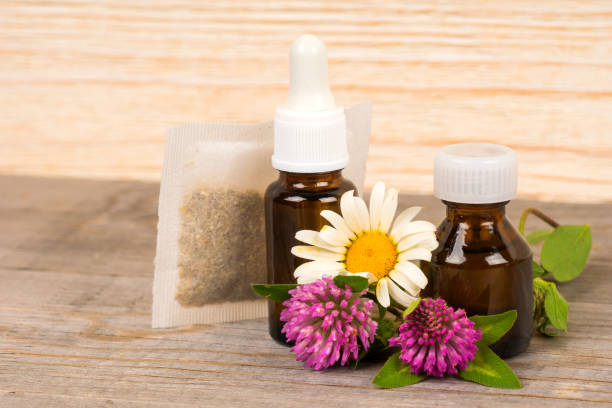 istock chamomile and clover tea and essential oil in small bottles 1132266221