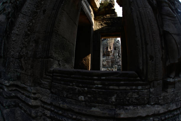 Stone face at the Bayon Temple the Tempel Ruins of Angkor Thom in the Temple City of Angkor near the City of Siem Reap in the west of Cambodia.  Cambodia, Siem Reap, April 2014