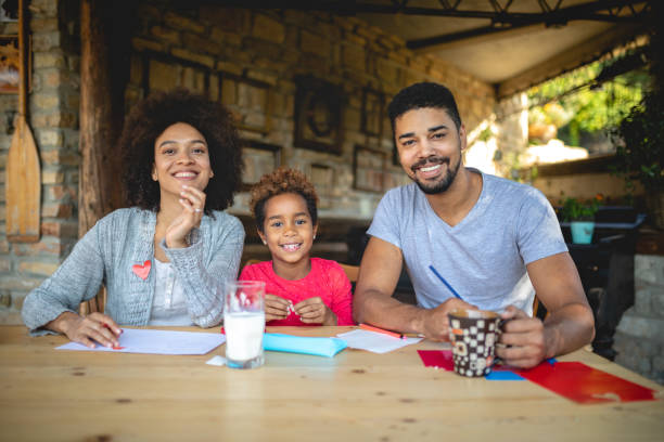 istock Beautiful young family doing homework 1132269251