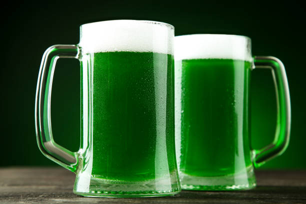 istock St. Patrick's Day. Green beer in mugs on dark background 1132269441