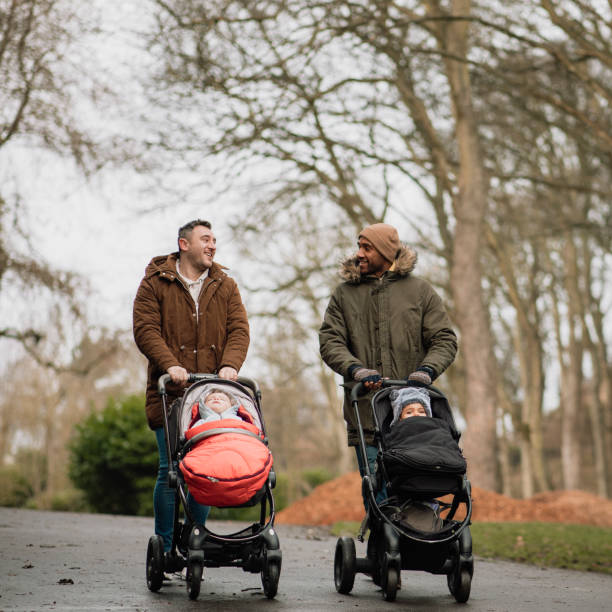istock Two Dads Strolling in the Park with Their Sons 1132270919