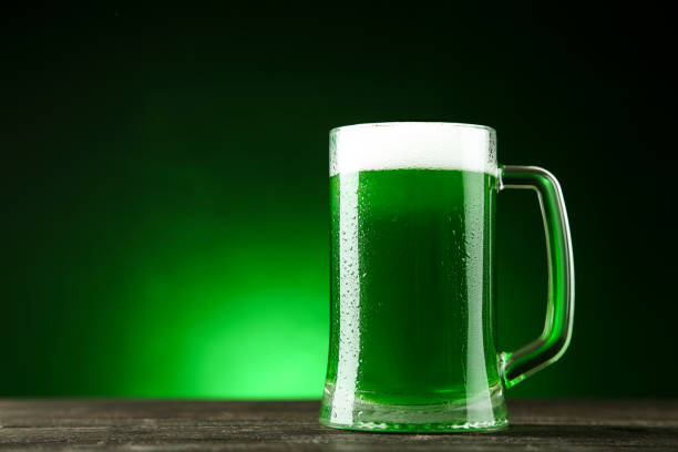 istock St. Patrick's Day. Glass mug with green beer on dark background 1132271251