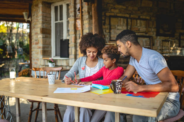 istock Lovely serene parents helping their daughter with homework 1132271331