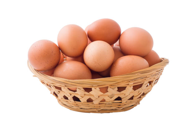 istock Chicken eggs in basket on isolated white background. 1132271520