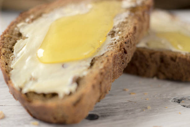 istock Pieces of bread with butter and honey, macro 1132272259