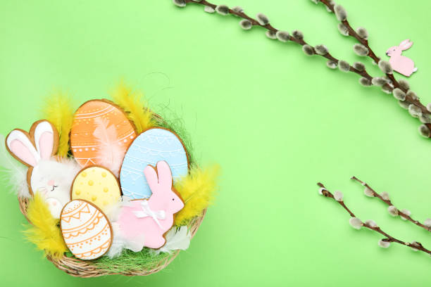 istock Easter gingerbread cookies in basket with willow branch on green background 1132272314