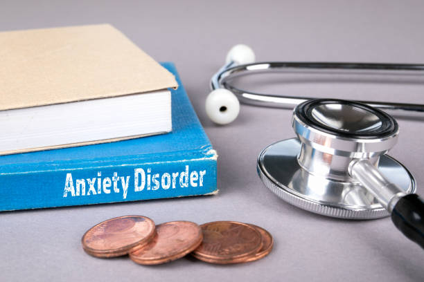istock Anxiety Disorder. Blue book on a grey office table 1132272561