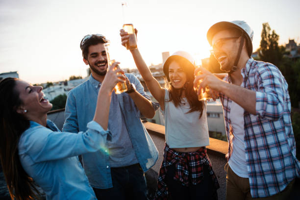 istock Group of happy friends having party on rooftop 1132272913