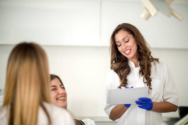 istock Dentist and her assistant performing dental examination 1132273255