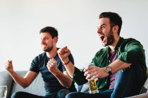 istock Two guys watching football match on TV 1132273415