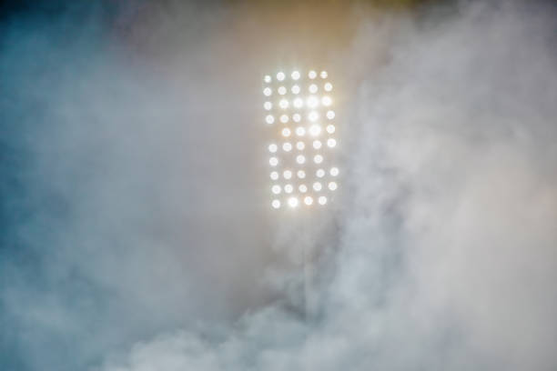 istock stadium lights and smoke 1132275173