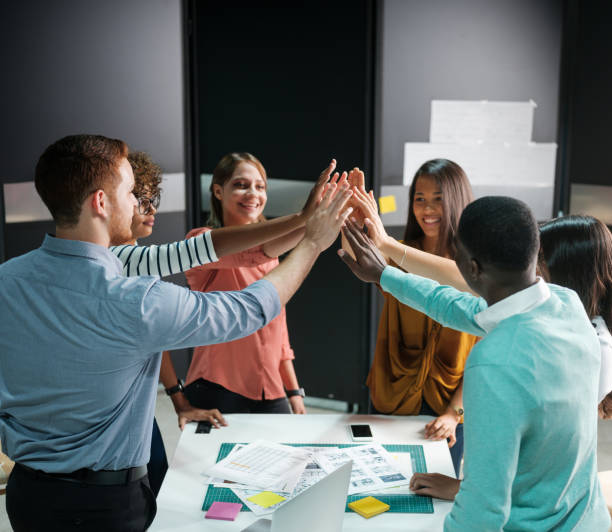 istock Successful business people celebrating with a high five 1132275199