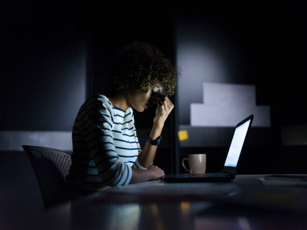 istock Exhausted African American working late 1132275312