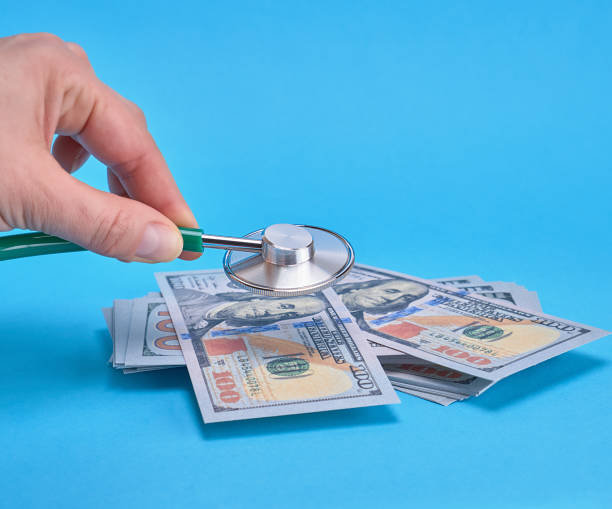 istock paper money and a medical stethoscope 1132276369