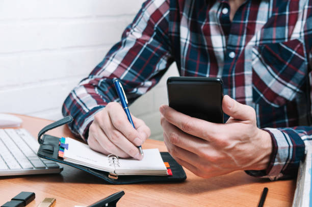 istock Business man writes in a notebook. The concept of office work 1132276491