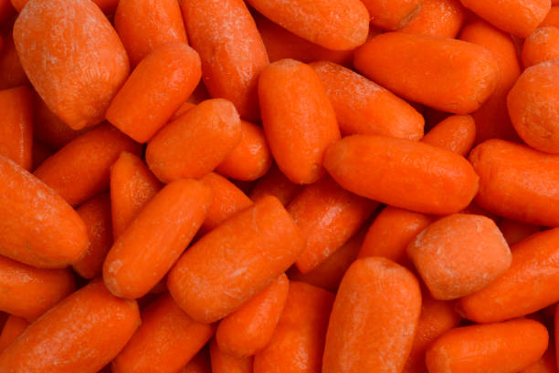 istock Little fresh carrots as a background. Snack. 1132281465