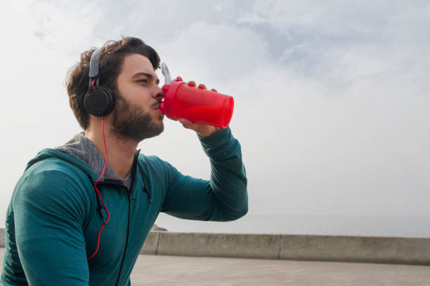 istock Young Man Drinking His Protein Shake After Outside Workout on A Foggy Day 1132282543