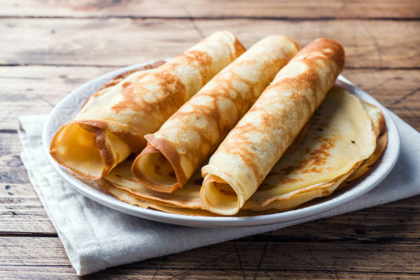 istock Thin pancakes on a plate. Wooden background. Close up. 1132282896