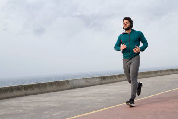 istock Active Young Man Jogging on A Foggy Winter Day 1132283165