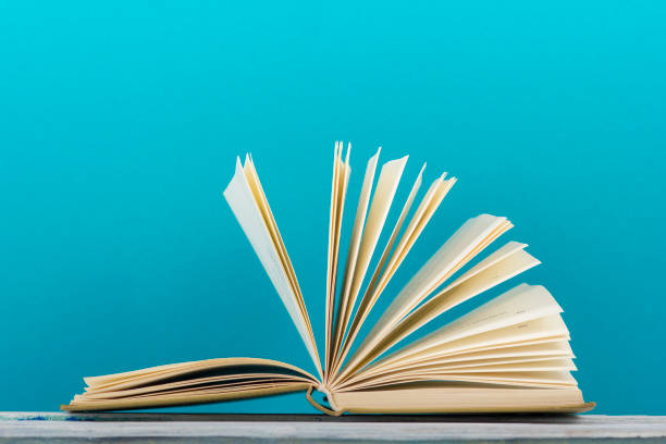 istock Open book, hardback books on wooden table. Back to school. Copy space. 1132284177