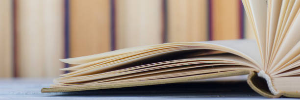 istock Open book, hardback books on wooden table. Back to school. Copy space. 1132284186