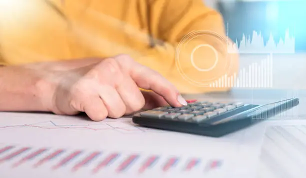 Photo of Hands of a female accountant working on financial documents