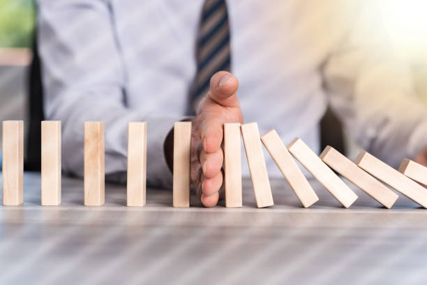 istock Concept of business control by stopping domino effect, light effect 1132286924