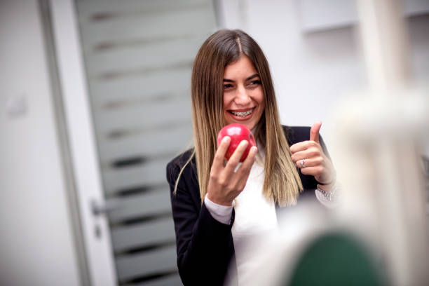 istock Young woman holding a red apple 1132286950