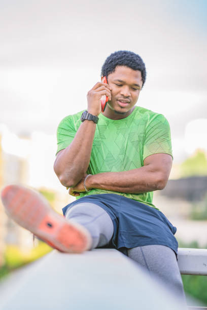 istock Young man using smart phone in public park 1132287804