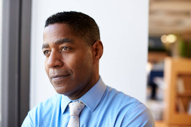 istock Smiling Mature  Businessman In Modern Office Standing By Window 1132288531
