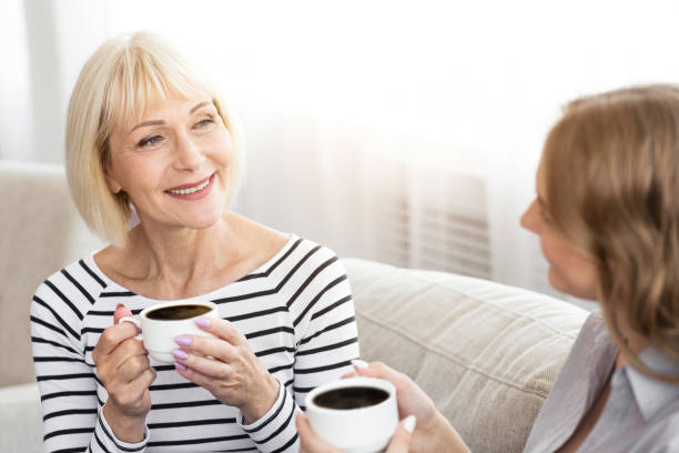 istock Mature mother and her daughter drinking coffee 1132291756