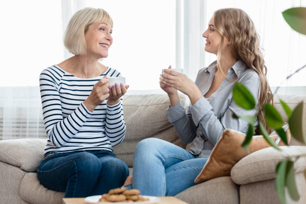istock Mother and daughter chatting over cup of tea 1132291759
