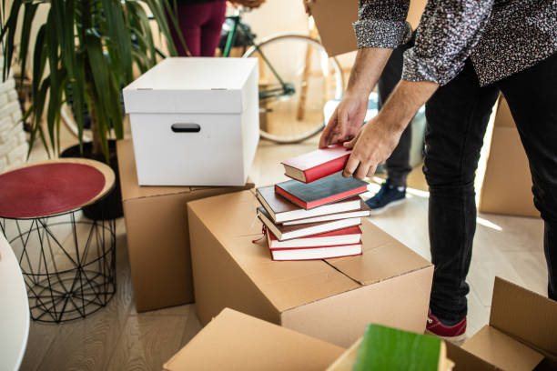 istock Pile of books on cardboard box 1132293139