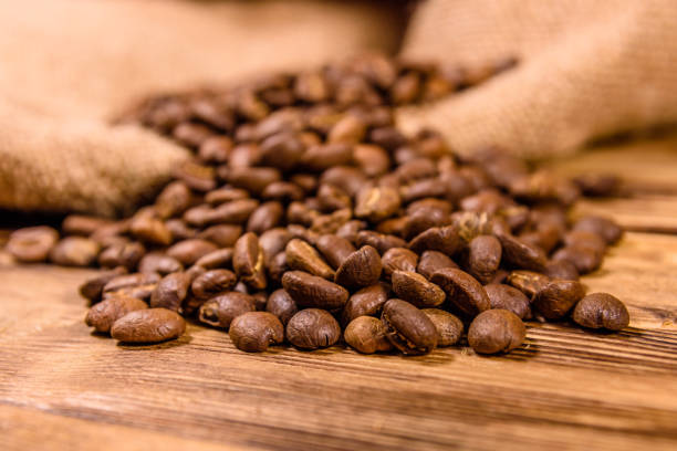 istock Sackcloth and scattered coffee beans on wooden table 1132294608