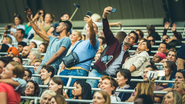 istock People in a football stadium taking selfies 1132295687