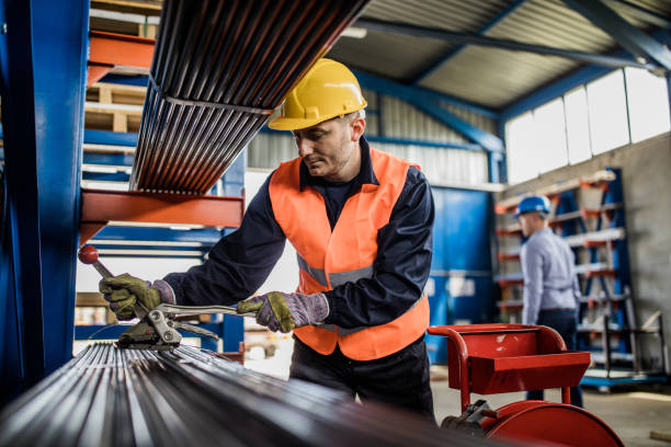 istock Metal worker using clamp while working on steel in a factory. 1132295729