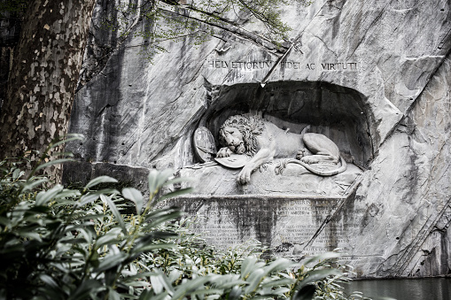 LUCERNE, SWITZERLAND - APRIL 16: Lion Monument, a exhausted lion carved in a rock on April 16, 2015 in Luzern. Designed by Bertel Thorvaldsen and hewn in 1820