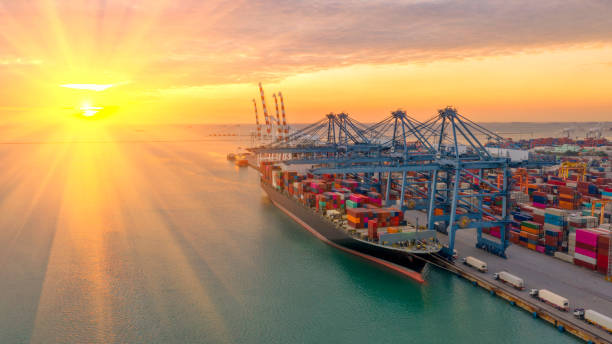 istock Container ship in export and import business logistics and transportation. Cargo and container box shipping to harbor by crane. Water transport International. Aerial view and top view. 1132297793