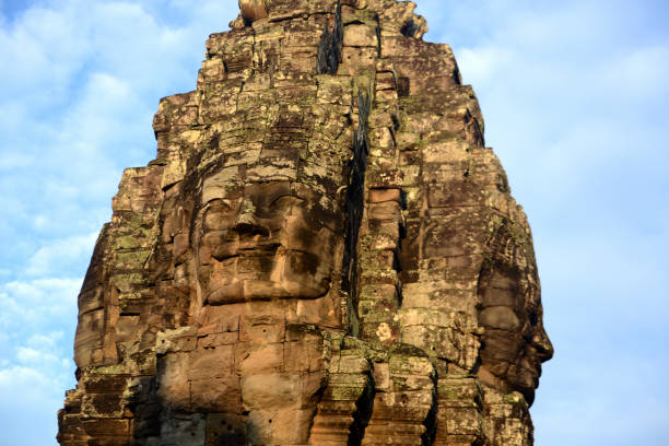 Stone face at the Bayon Temple the Tempel Ruins of Angkor Thom in the Temple City of Angkor near the City of Siem Reap in the west of Cambodia.  Cambodia, Siem Reap, April 2014